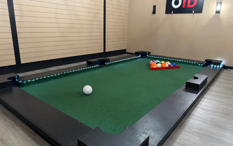 Footpool table with soccer balls and OTD wall sign in the private party room