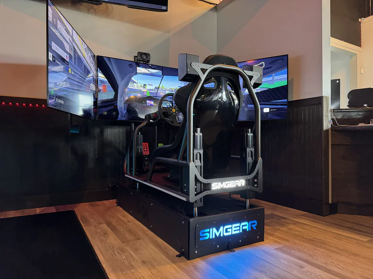 Rear view of SimGear racing simulator with triple screens at On The Dunes Sports