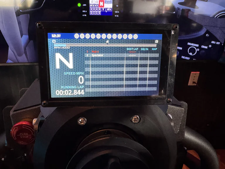 Racing simulator touchscreen showing leaderboard positions lap delta and gap data