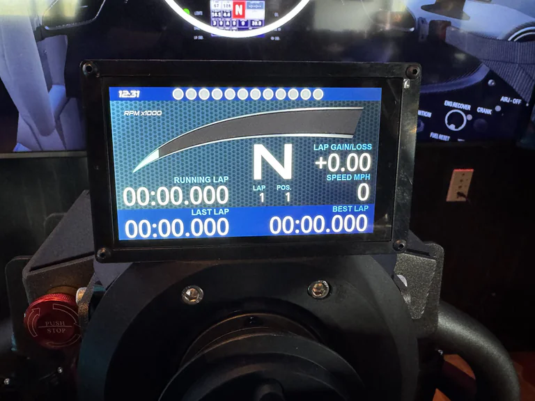 Touchscreen racing simulator display with running lap speed gear and best lap data