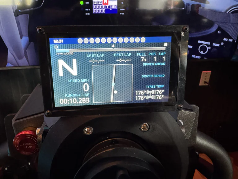 Racing simulator touchscreen showing track map gear speed lap data and tire temperatures