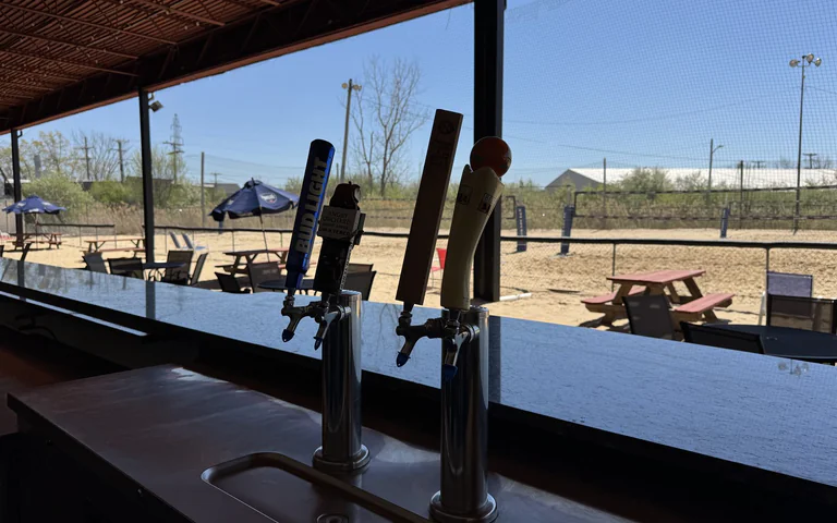 Draft taps overlooking the outdoor volleyball courts at On The Dunes Sports in Commerce Township