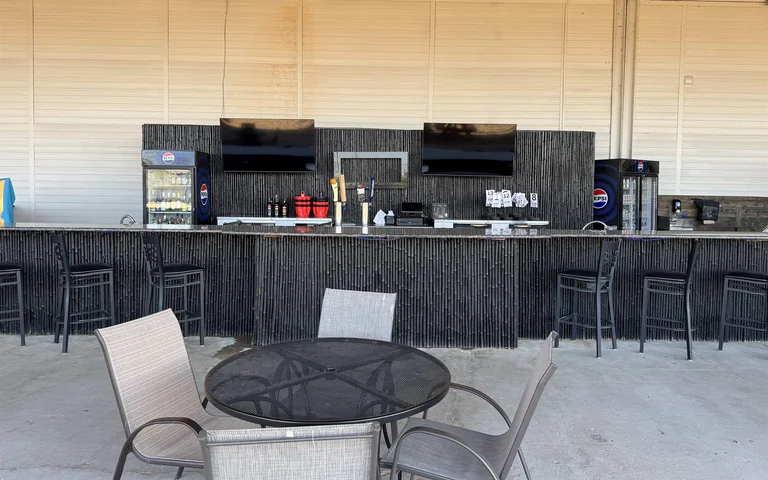Outdoor Tiki bar counter at On The Dunes Sports near the volleyball courts