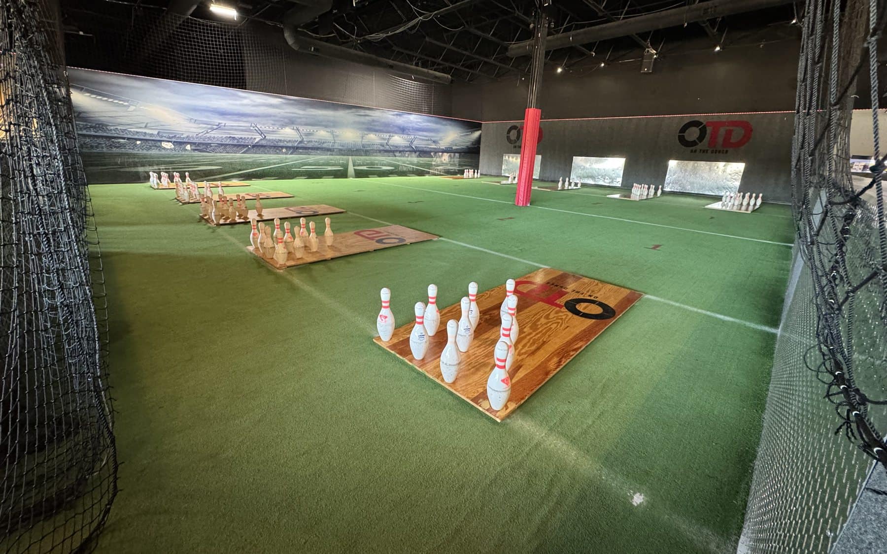 Football bowling lanes with pins set up at On The Dunes Sports in Commerce Township