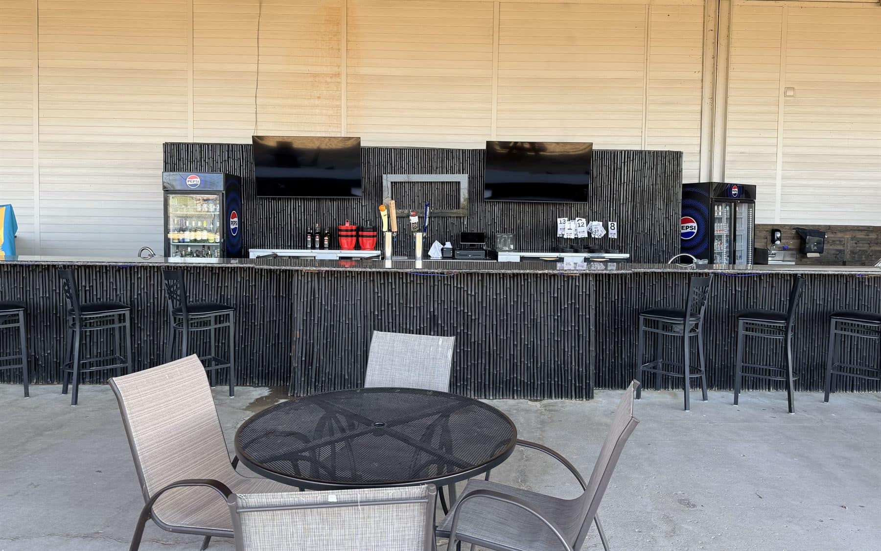 Outdoor Tiki bar counter at On The Dunes Sports near the volleyball courts